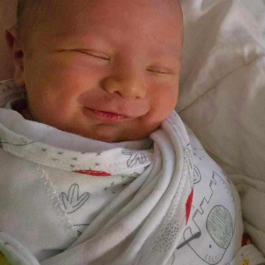 Baylor is registered to the contest to win money with this photo: baby, bed, blanket, child, closeup, clothing, cozy, cute, face, indoors, infant, newborn, peaceful, portrait, resting, sleep, sleeping, smile, soft, wrapped