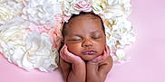 Ailai is registered to the contest to win money with this photo: baby, sleeping, flower_crown, newborn, infant, pink_background, white_flowers, peaceful, portrait, cute, soft_lighting, close_up, resting, adorable, child, headshot, hands_under_chin, skin, face, calm