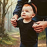 Elody is registered to the contest to win money with this photo: toddler, child, baby, hands, headband, black_clothing, outdoor, forest, path, nature, walking, support, adult_hands, portrait, cute, young_child, person, daylight, fall, exploration