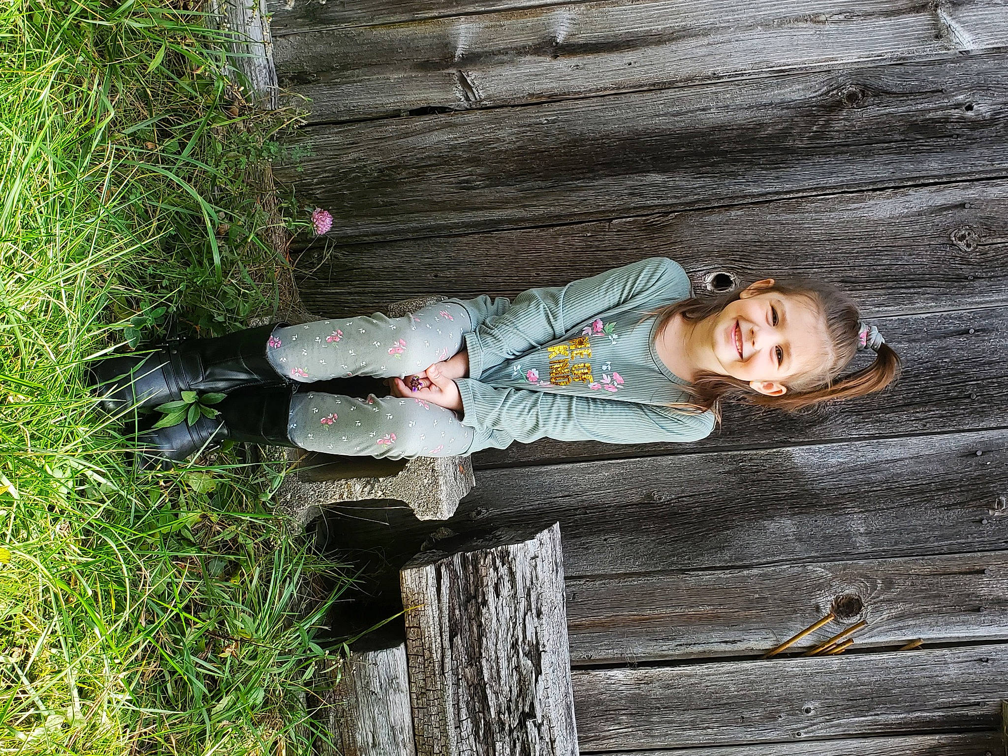 Adalyne is registered to the contest to win money with this photo: boot, fun, grass, happy, hat, joy, leisure, people_in_nature, person, plant, portrait_photography, shoe, sitting, smile, tree, trunk, wood