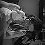 dog, person, indoor, black_and_white, affection, pet, smile, face, hair, furniture, wall_art, backpack, holding, close_up, cute, love, companion, portrait, animal, warmth