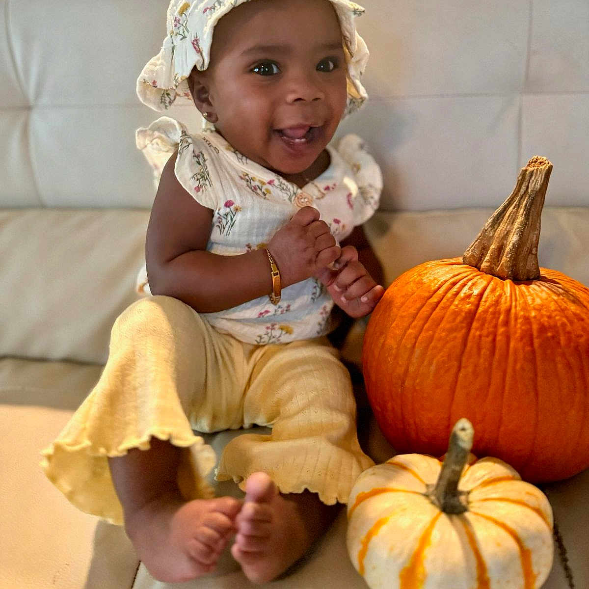 Layla joined the competition — help win amazing prizes! baby, bodypart, clothing, face, finger, food, hand, happy, hat, head, person, photography, plant, portrait, produce, pumpkin, scarf, sitting, squash, vegetable