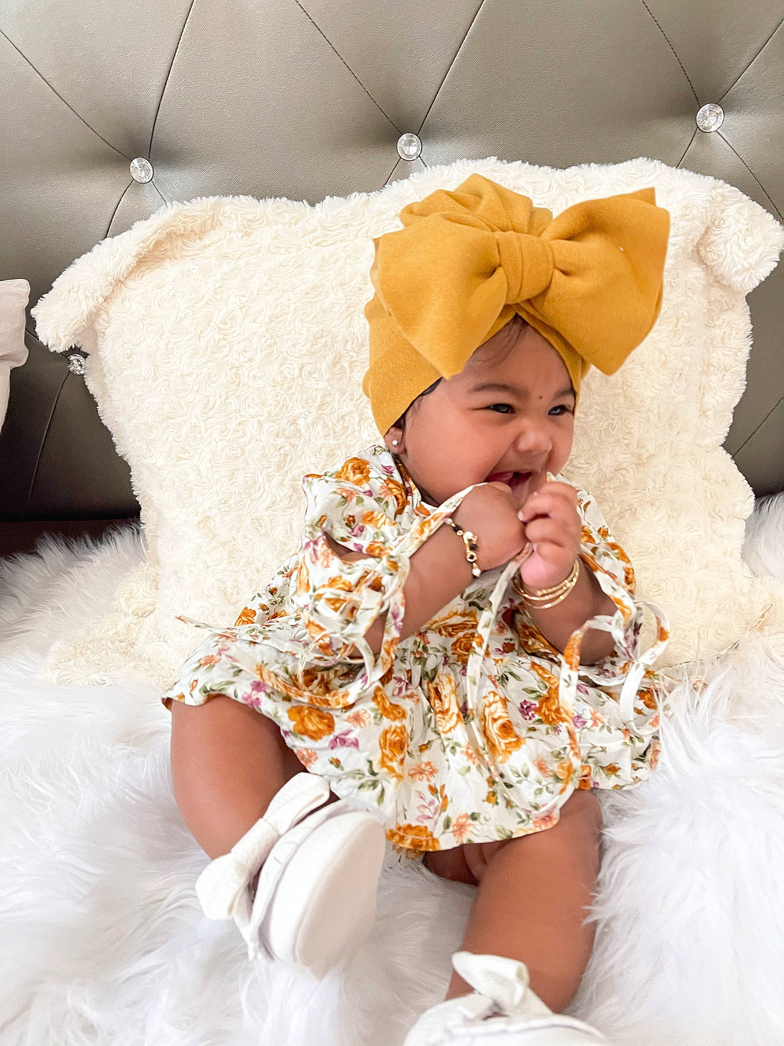 Kelsey is registered to the contest to win money with this photo: baby, baby_toddler_clothing, bridal_accessory, comfort, dress, embellishment, event, eye, fashion_design, happy, hat, headgear, headpiece, headwear, human_body, peach, person, ruffle, skin, smile
