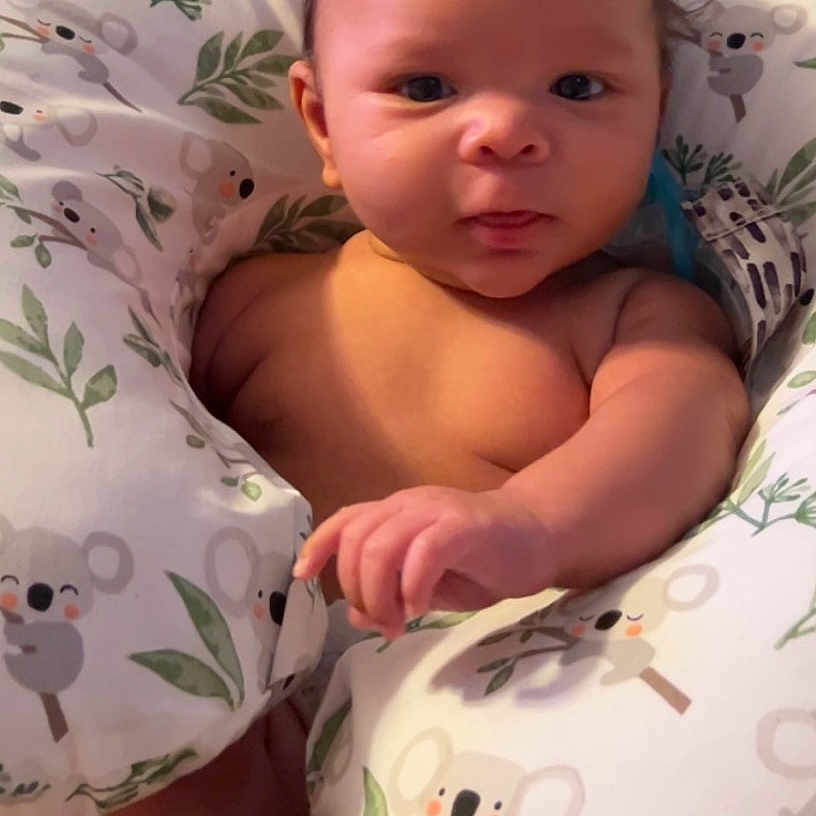 Jaxsyn is registered to the contest to win money with this photo: baby, bed, bedroom, blanket, bodypart, cushion, face, finger, furniture, hand, head, homedecor, indoors, newborn, person, photography, pillow, portrait, quilt, room