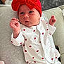 Nancy joined the competition — help win amazing prizes! baby, infant, red_bow, white_onesie, hearts_pattern, hand, face, headwear, newborn, cute, indoors, soft_fabric, person, sleepwear, lying_down, skin, expression, comfort, couch, blanket