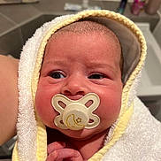 Nancy is registered to the contest to win money with this photo: baby, newborn, pacifier, towel, wrapped, infant, face, hand, cute, expression, skin, indoors, person, closeup, head, blanket, newborn_baby, bathroom, soft, child