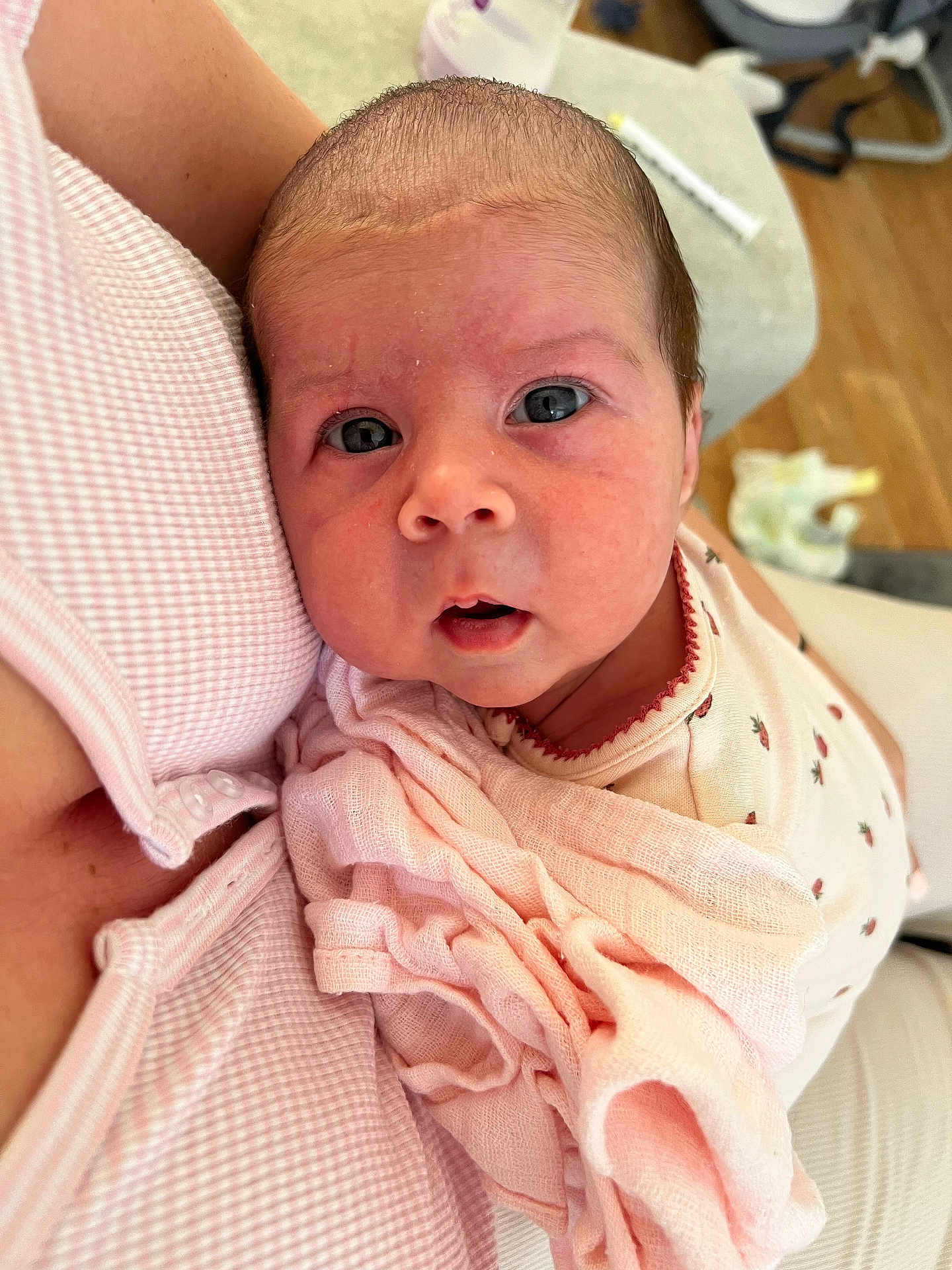 Nancy is registered to the contest to win money with this photo: baby, newborn, infant, child, pink, blanket, close_up, face, eyes, skin, person, holding, caring, soft, comfort, indoor, clothing, fabric, parent, love
