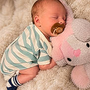 Preston joined the competition — help win amazing prizes! baby, sleeping, child, infant, portrait, pacifier, plush_toy, elephant, stuffed_animal, blanket, cozy, indoors, swaddled, striped_clothing, socks, peaceful, nursery, cuddling, soft_lighting, close_up