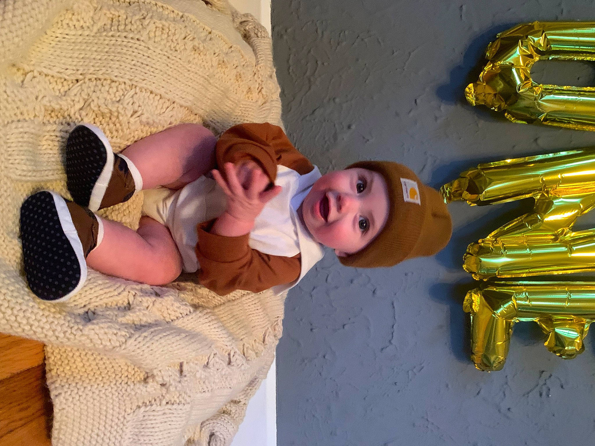 Frankie joined the competition — help win amazing prizes! baby, child, comfort, foot, fun, hat, headgear, headwear, human_leg, knee, leisure, linens, person, room, sandal, smile, sock, sun_hat, thigh, toddler