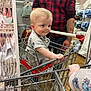 toddler, shopping_cart, child, store, clothing, adult, hand, metal, floor, plaid_shirt, tattoo, baby, shopping, aisle, rack, sleeve, casual, footwear, cute, curious