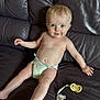 Elijah is registered to the contest to win money with this photo: baby, diaper, pacifier, drool, leather_couch, child, smile, skin, infant, sitting, cute, young_child, indoors, furniture, relaxing, person, tongue, happy, small_child, playful