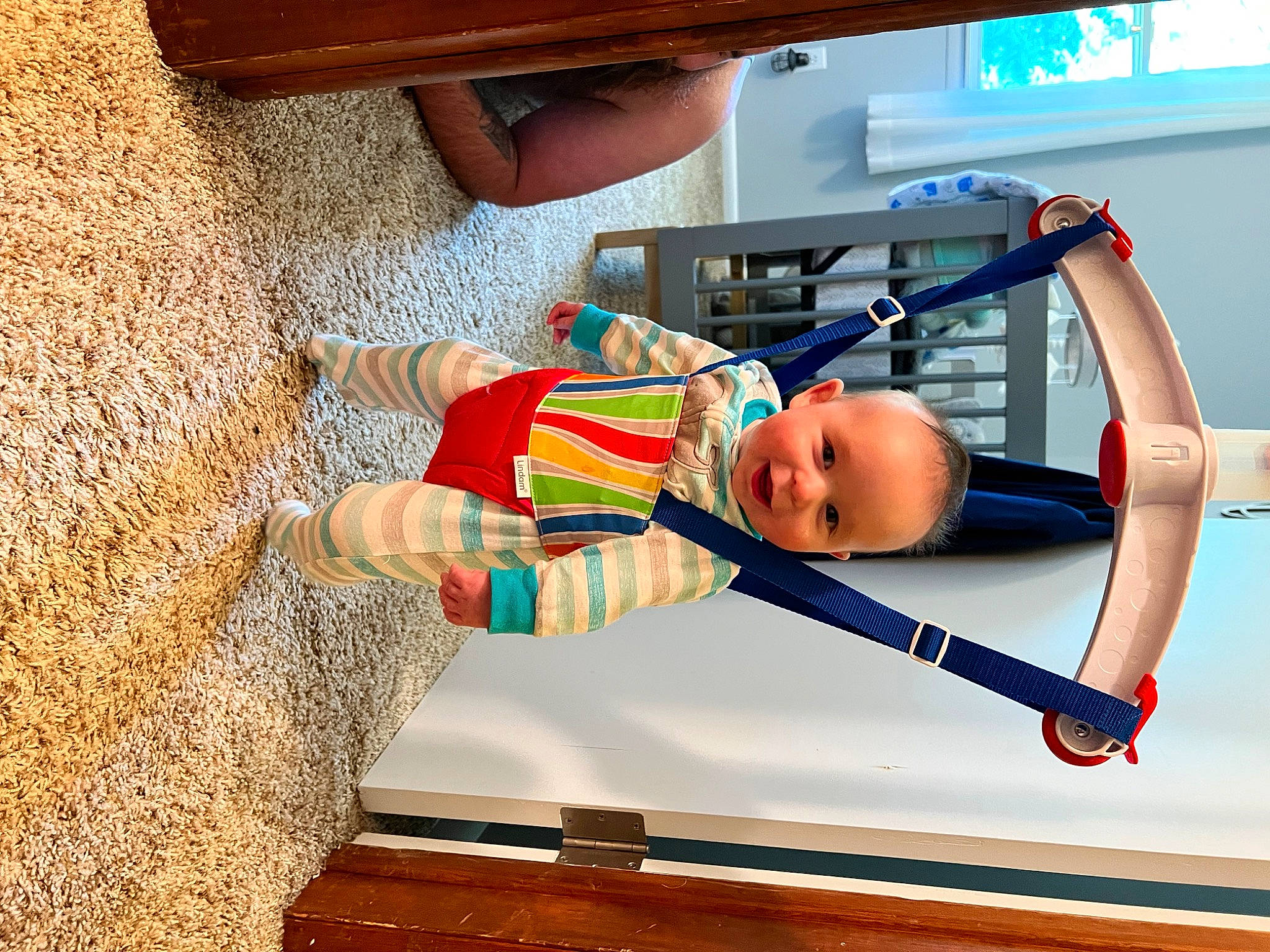 Owen is registered to the contest to win money with this photo: baby, baby_products, baby_toddler_clothing, child, elbow, electric_blue, flooring, fun, hardwood, home_appliance, leisure, machine, orange, person, play, recreation, room, smile, t_shirt, toddler