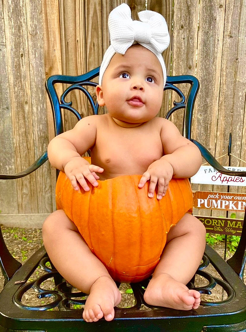 Matana joined the competition — help win amazing prizes! baby, baby_toddler_clothing, calabaza, chair, child, eye, fun, grass, happy, head, human_body, leisure, natural_foods, people_in_nature, person, plant, pumpkin, sitting, toddler, vegetable