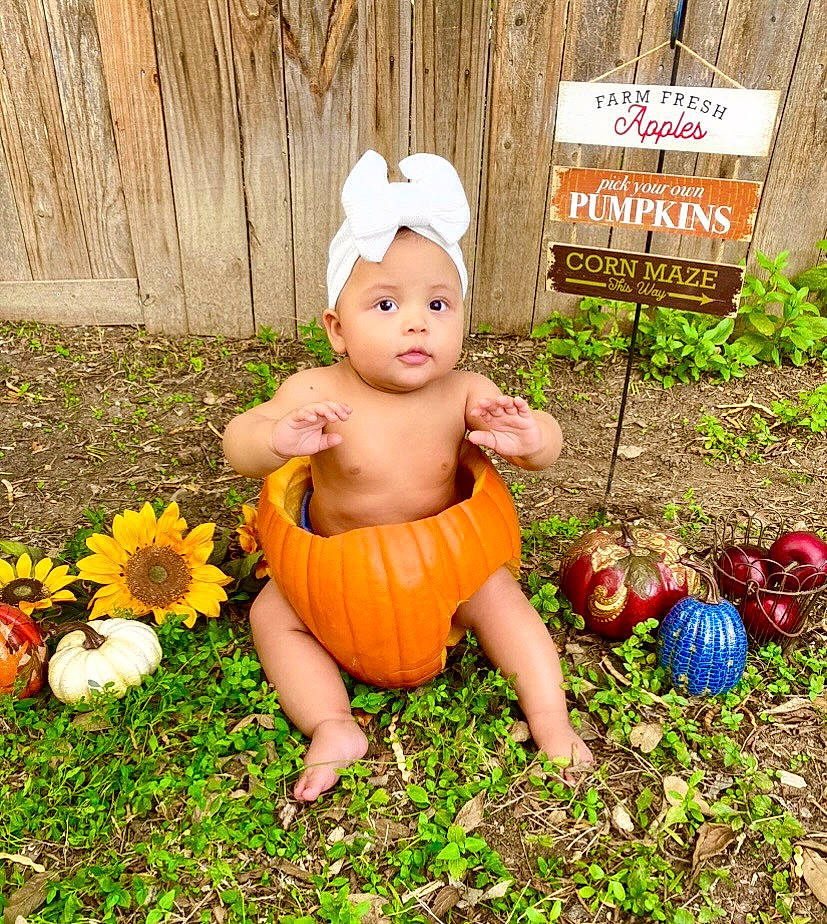 Matana joined the competition — help win amazing prizes! baby, baby_toddler_clothing, child, fawn, flower, flowerpot, fun, garden, grass, happy, headwear, holiday, lawn, lawn_ornament, people_in_nature, person, petal, plant, sitting, toddler