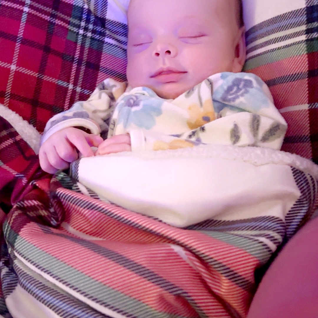 Paisley is registered to the contest to win money with this photo: baby, bed, bedroom, blanket, clothing, couch, cushion, dress, face, furniture, hat, head, homedecor, indoors, newborn, person, photography, portrait, quilt, sleeping