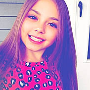 Arabella joined the competition — help win amazing prizes! child, girl, smiling, braces, teeth, long_hair, portrait, close_up, pink_shirt, leopard_print, pattern, front_door, porch, house_siding, door_handle, happy, posed, colorful_filter, youth, fashion