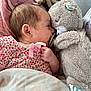 Cello is registered to the contest to win money with this photo: baby, blanket, child, close_up, comfort, cozy, cushion, cute, doll, face, hand, indoor, infant, pacifier, patterned_clothing, pink_clothing, resting, sleeping, soft_toy, teddy_bear