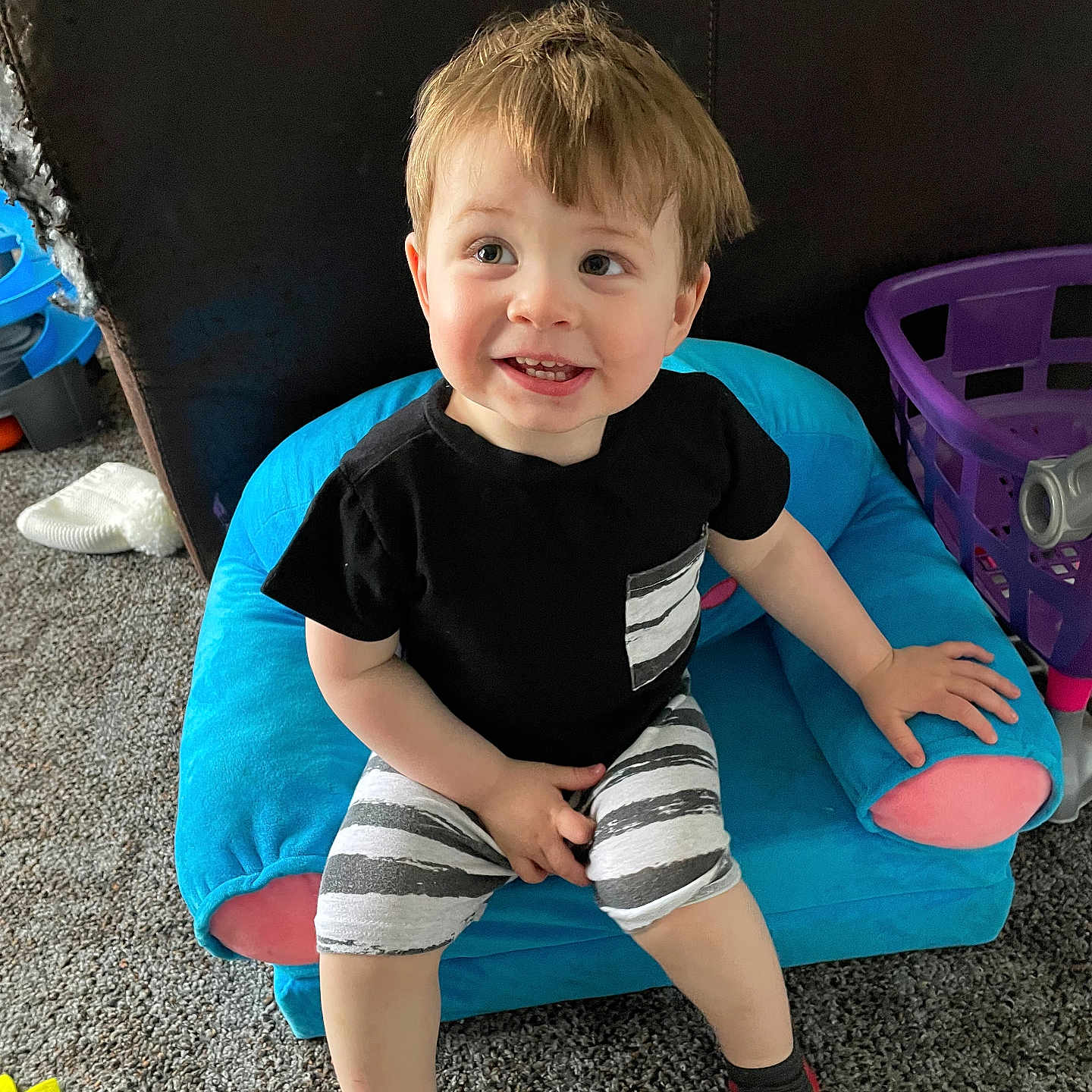 Jaxson is registered to the contest to win money with this photo: bodypart, boy, child, clothing, couch, cushion, face, finger, footwear, furniture, head, homedecor, male, person, photography, portrait, shoe, shorts, sitting, t_shirt