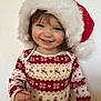 toddler, child, smiling, face, santa_hat, christmas_sweater, holiday, festive, red, white, patterned_clothing, cute, happy, portrait, indoor, young_child, winter_clothing, holiday_theme, fun, celebration