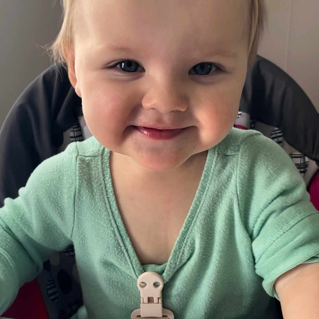 Scarlett joined the competition — help win amazing prizes! baby, child, toddler, smiling, portrait, high_chair, floral_headband, bow, mint_green_clothing, indoors, seated, face, blue_eyes, blonde_hair, happy, infant, feeding_tray, home, close_up, photography