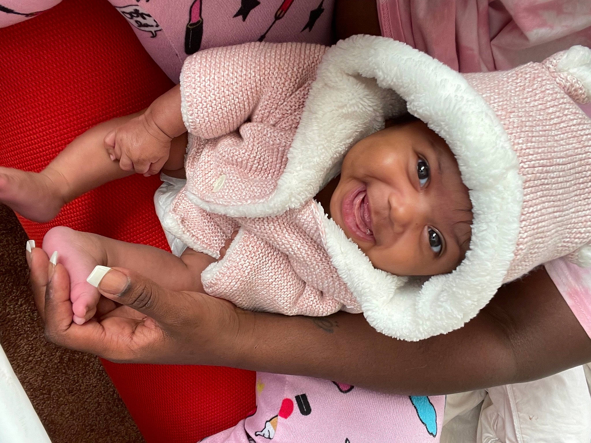 Aria joined the competition — help win amazing prizes! baby, baby_toddler_clothing, bonnet, child, comfort, facial_expression, foot, happy, headwear, joy, lap, laugh, linens, nail, person, skin, sock, textile, thumb, toddler