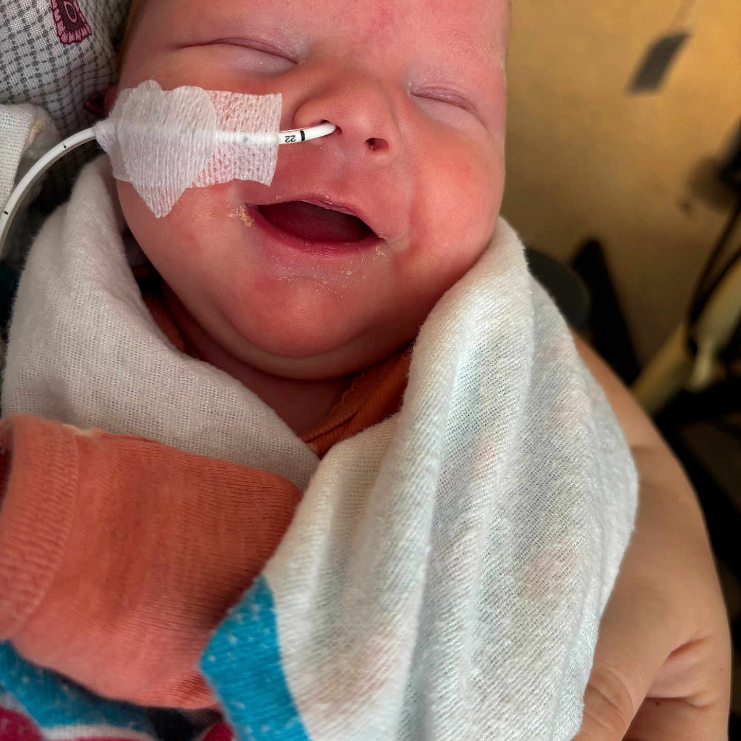 Mavis is registered to the contest to win money with this photo: architecture, baby, blanket, bodypart, building, clothing, couch, face, finger, glove, hand, hat, head, hospital, mouth, newborn, person, photography, portrait, towel