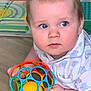baby, child, toy, colorful, ball, floor, blue_eyes, clothing, patterned_mat, hand, face, crawling, indoor, play, infant, cute, expression, young, person, closeup