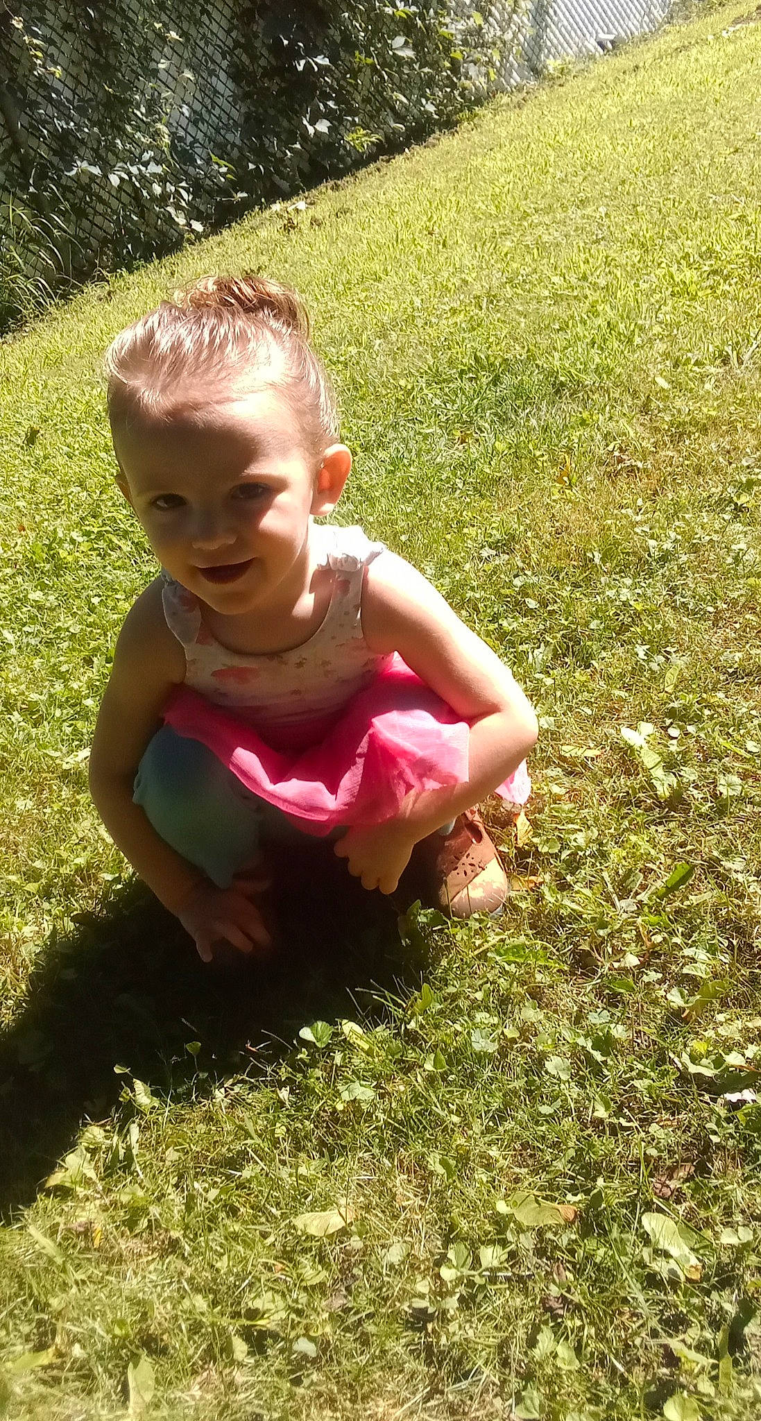 Kaite K is registered to the contest to win money with this photo: baby_toddler_clothing, botany, finger, grass, grass_family, grassland, groundcover, hand, happy, head, human_body, joy, lawn, leisure, meadow, people_in_nature, person, plant, recreation, smile