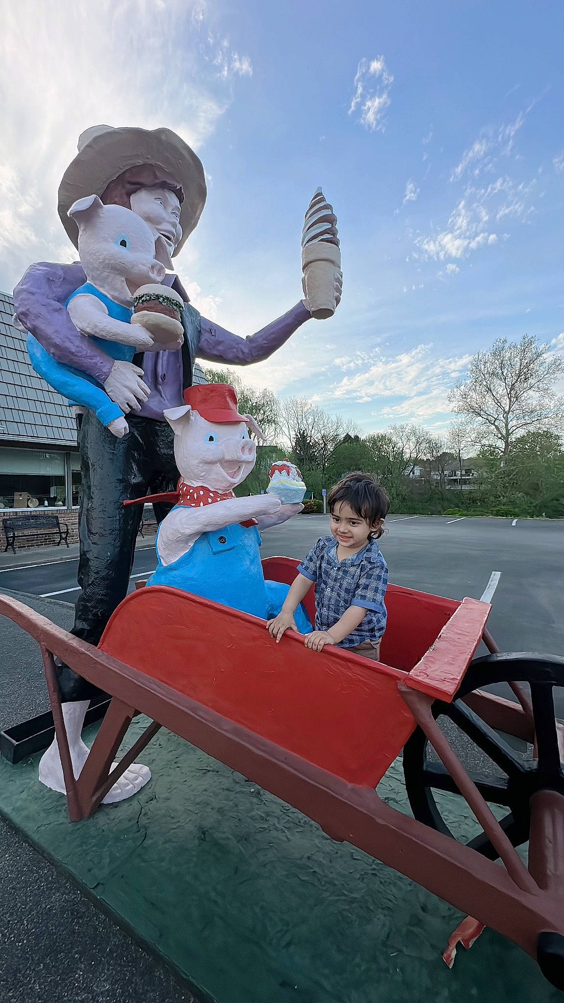 Abram is registered to the contest to win money with this photo: child, city, cloud, fun, happy, hat, joy, lap, leisure, musical_instrument, outdoor_furniture, person, recreation, sitting, sky, sun_hat, t_shirt, toddler, tourism, travel