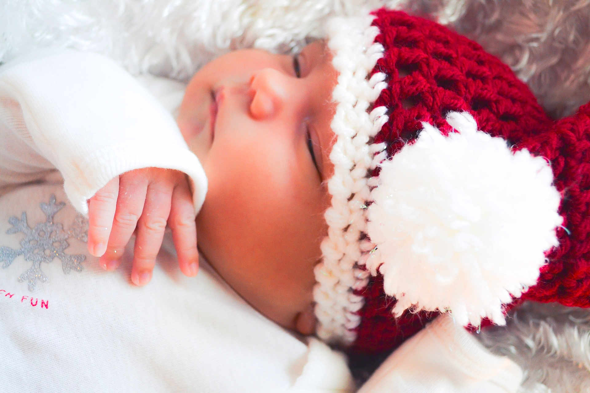 Jovina is registered to the contest to win money with this photo: baby, sleeping, hat, knitted, pom_pom, red, white, outfit, snowflake, hand, soft, blanket, cozy, cute, infant, peaceful, close_up, portrait, child, warm
