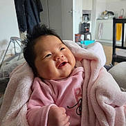 Anitha participe au concours pour gagner de l'argent avec cette photo : baby, blanket, child, cozy, cute, fist, furniture, happy, home, indoor, infant, kitchen, person, pink_clothing, portrait, smile, soft_texture, warm, wrapped, young