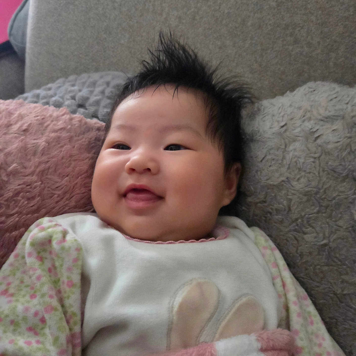 Anitha participe au concours pour gagner de l'argent avec cette photo : baby, blanket, child, clothing, comfortable, couch, cozy, cute, face, hair, happy, indoors, infant, person, pillow, portrait, resting, smiling, soft, warm