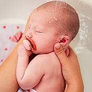 Zoé participe au concours pour gagner de l'argent avec cette photo : baby, infant, pacifier, bath, water, hands, skin, towel, heart_pattern, sleeping, cute, newborn, child, closeup, parent, care, gentle, wet, soft, love