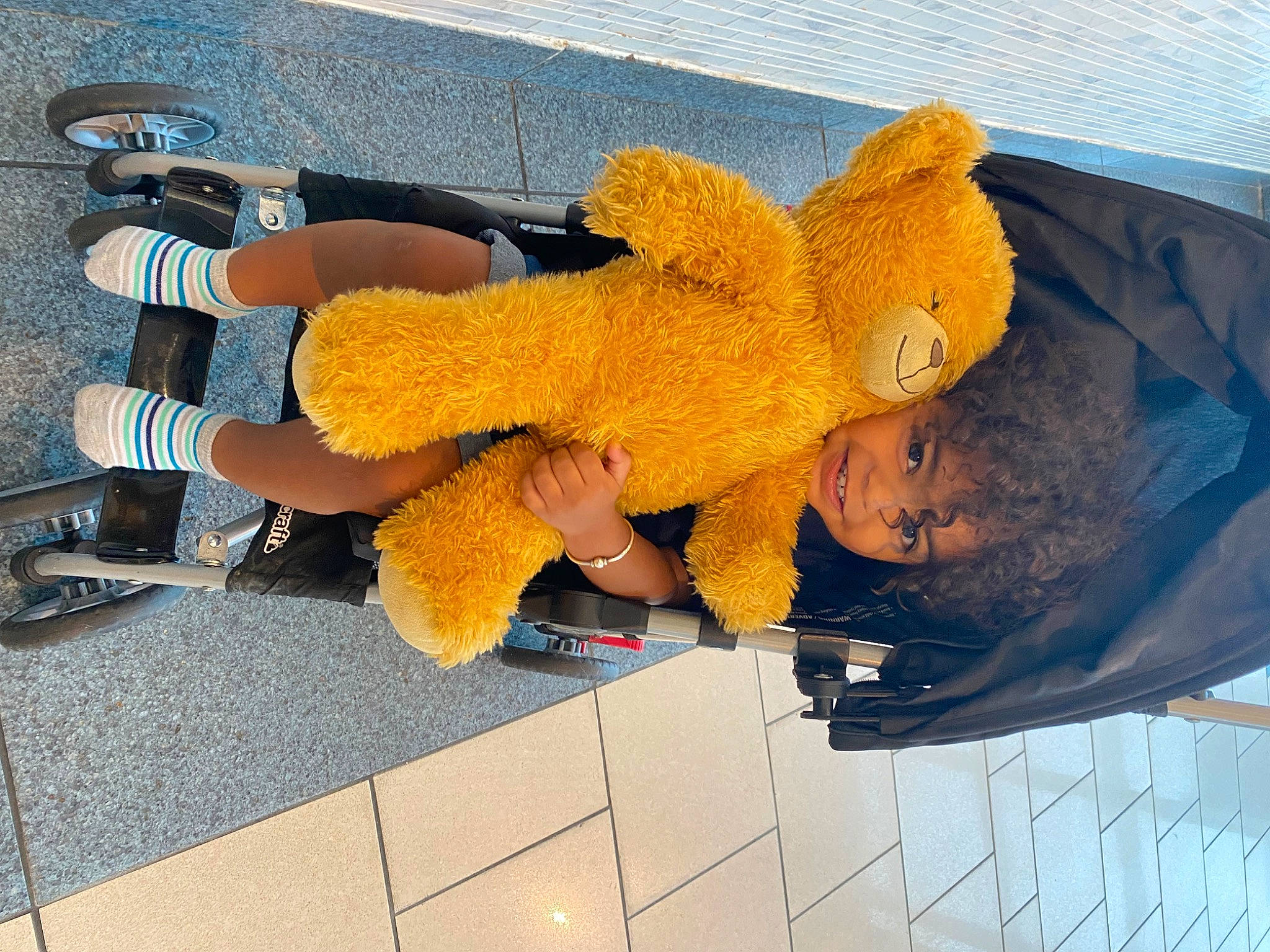 Braedyn is registered to the contest to win money with this photo: electric_blue, flooring, foot, fun, gesture, glove, human_leg, joy, knee, person, thumb, toy, walking_shoe