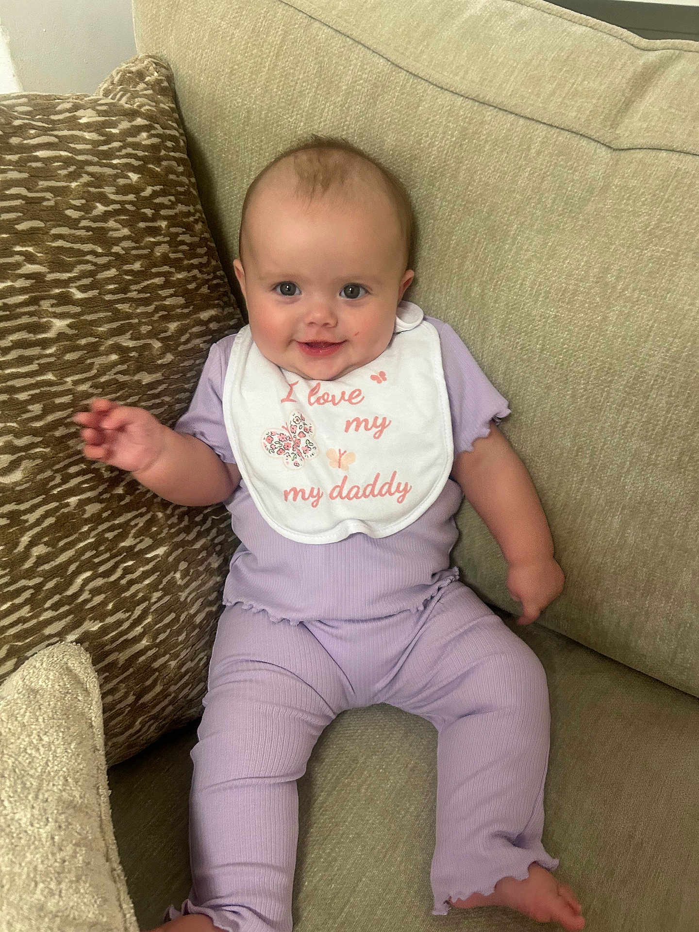 Taliah joined the competition — help win amazing prizes! baby, child, smiling, sitting, pajamas, bib, couch, cushion, indoor, happy, infant, person, face, clothing, home, cute, comfortable, relaxed, portrait, young