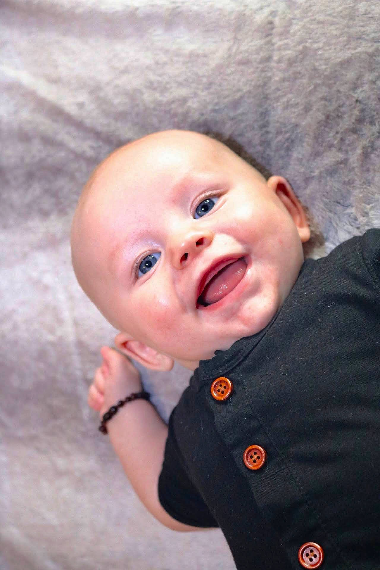 Colvin is registered to the contest to win money with this photo: baby, baby_laughing, baby_toddler_clothing, cheek, child, collar, comfort, eye, flash_photography, fun, gesture, happy, iris, lip, mouth, nose, person, skin, sleeve, smile