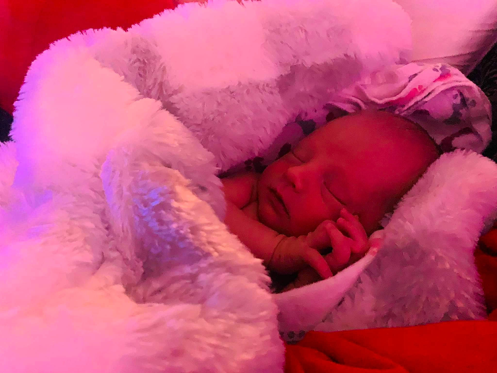 Dylan Jr is registered to the contest to win money with this photo: baby, baby_sleeping, child, close_up, comfort, event, fashion_accessory, fun, fur, fur_clothing, happy, linens, magenta, person, petal, pink, purple, skin, textile, toddler