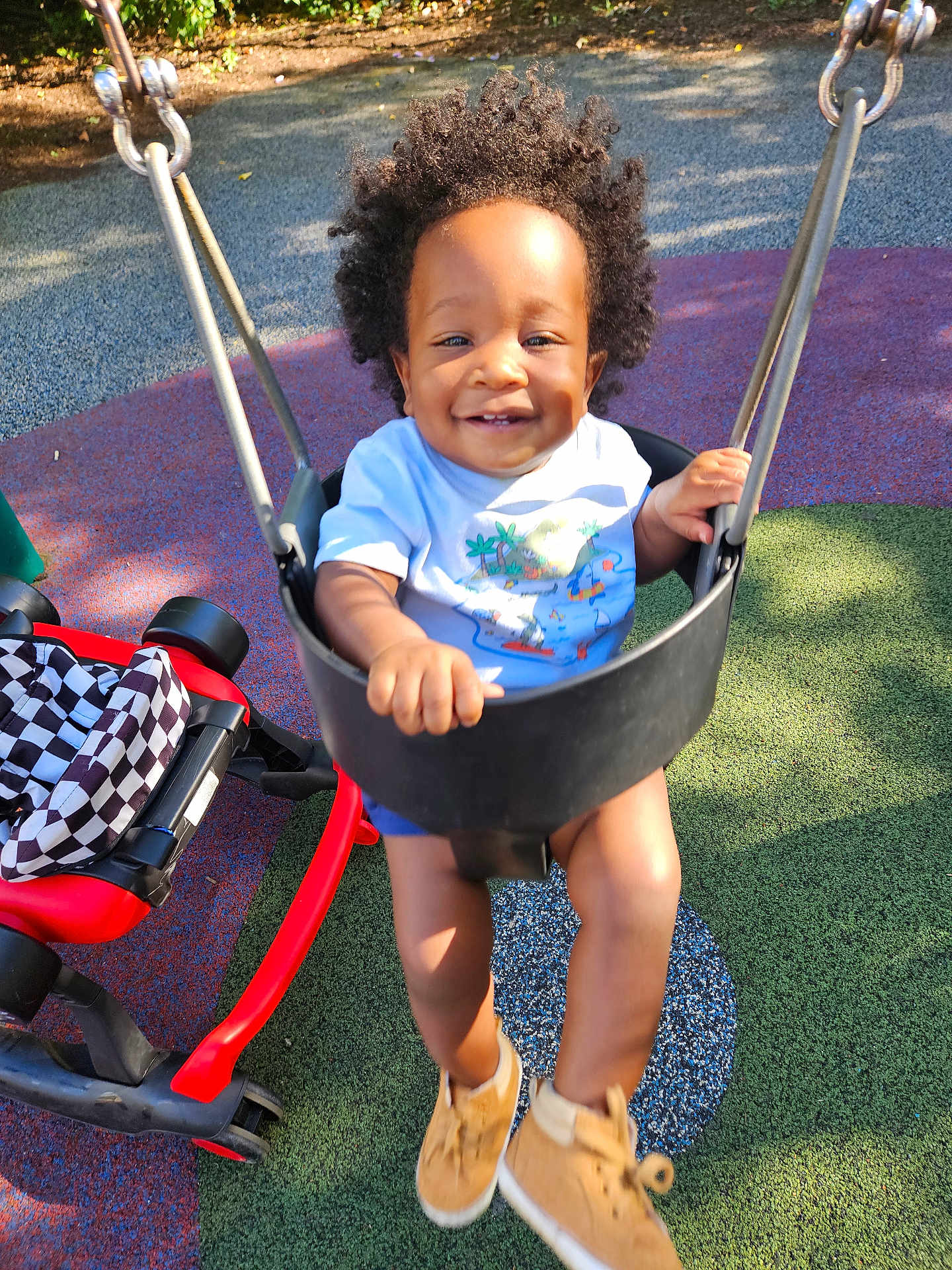 Kellan is registered to the contest to win money with this photo: toddler, child, swing, playground, smiling, curly_hair, shoes, sunlight, outdoor, happy, playing, park, seat, toy, footwear, person, daylight, fun, recreation, leisure