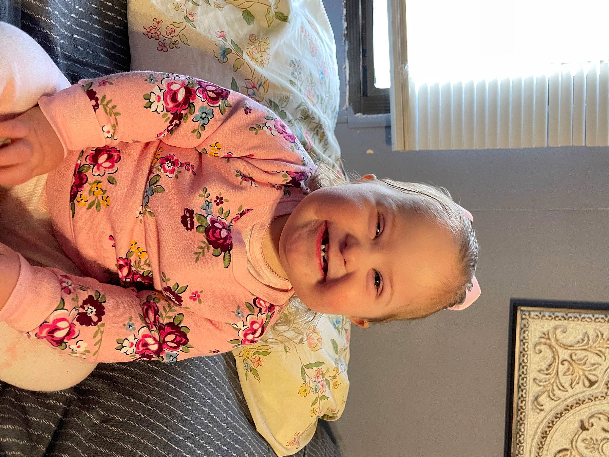 Maddilyn is registered to the contest to win money with this photo: abdomen, baby, baby_laughing, child, curtain, facial_expression, fun, happy, human_body, joy, laugh, magenta, neck, pattern, peach, person, room, skin, sleeve, smile