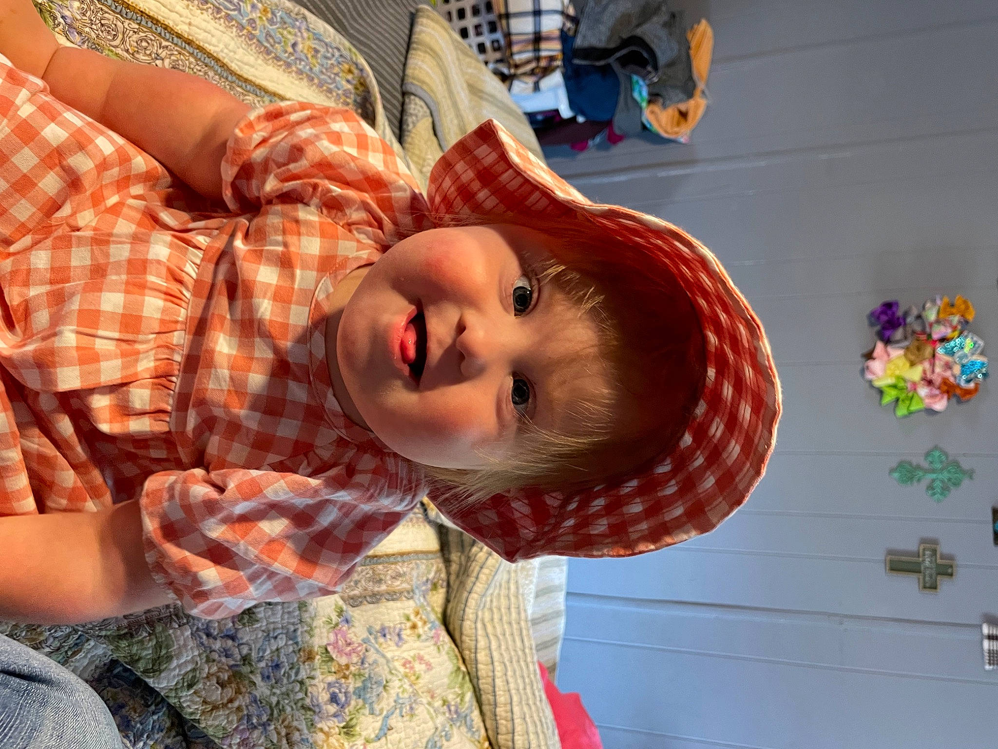 Maddilyn is registered to the contest to win money with this photo: child, eye, eyewear, fun, hairstyle, happy, hat, mouth, orange, pattern, person, plaid, room, selfie, smile, sun_hat, tartan, textile, toy, visual_arts