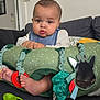 baby, infant, child, cushion, toys, sofa, living_room, foot, hand, mirror, green, blue, plush, comfort, curious, indoor, person, cute, seated, home