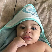 Nathaniel joined the competition — help win amazing prizes! baby, child, towel, hooded_towel, blanket, face, skin, hand, portrait, indoor, cute, resting, young, expression, cozy, soft_texture, infant, looking_at_camera, sleepwear, relaxed