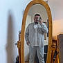 Mathias Gigault participe au concours pour gagner de l'argent avec cette photo : man, mirror, selfie, striped_shirt, glasses, cat, wooden_mirror, pants, sneaking_cat, shoes, room, floor, chair, phone, beard, casual, reflection, home, curious_cat, indoor