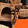 tabby_cat, cat, pet, feline, indoor, cat_tree, paws, fur, animal, relaxing, looking_at_camera, cozy, home, furniture, striped, cute, domestic_cat, resting, orange_pillow, blanket