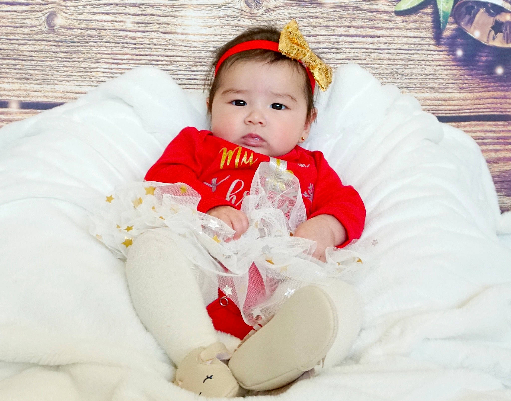 Kendra is registered to the contest to win money with this photo: baby, baby_toddler_clothing, child, child_model, comfort, hair_accessory, headband, headpiece, human, mouth, nose, person, photo_shoot, portrait_photography, toddler