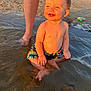 Adrian joined the competition — help win amazing prizes! toddler, child, beach, water, swim_trunks, sunlight, sand, legs, smiling, happy, summer, outdoor, barefoot, play, vacation, nature, person, sunset, fun, dinosaur_print