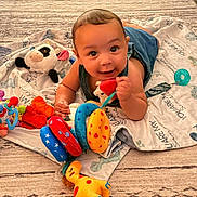 Elijah joined the competition — help win amazing prizes! baby, child, toy, plush, blanket, giraffe, panda, colorful, happy, smiling, indoor, floor, clothing, play, cute, infant, face, person, toddler, carpet