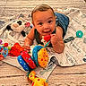 baby, child, toy, plush, blanket, giraffe, panda, colorful, happy, smiling, indoor, floor, clothing, play, cute, infant, face, person, toddler, carpet