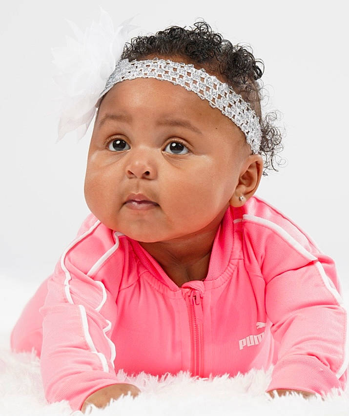 Liberty is registered to the contest to win money with this photo: arm, baby_toddler_clothing, cap, cheek, eye, facial_expression, flash_photography, gesture, happy, headwear, human_body, iris, lip, mouth, nose, outerwear, person, pink, skin, sleeve