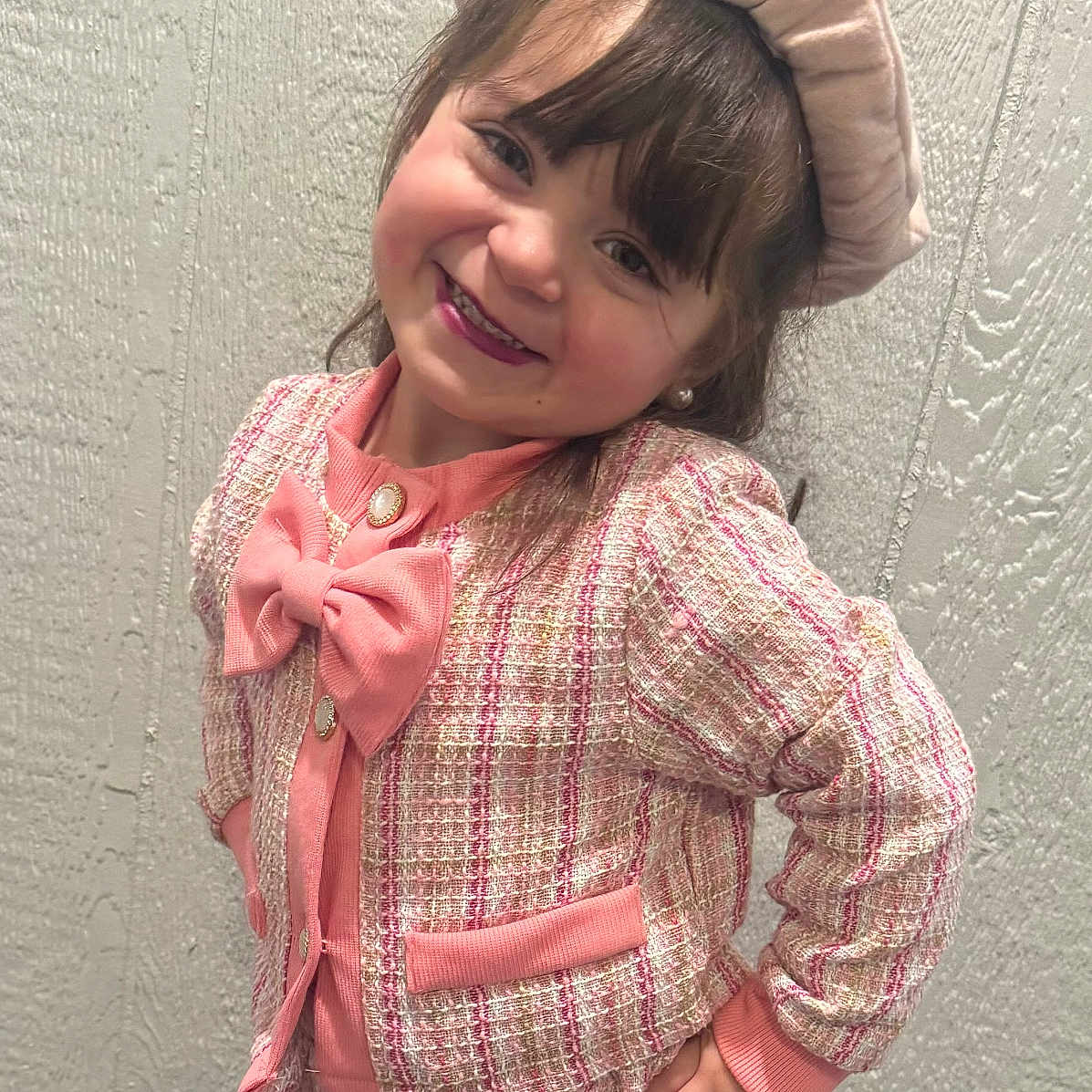 Melanie is registered to the contest to win money with this photo: beret, child, clothing, confident, cute, fashion, girl, hand_on_hip, happy, indoor, jacket, person, pink, plaid, portrait, posing, skirt, smile, wall, young